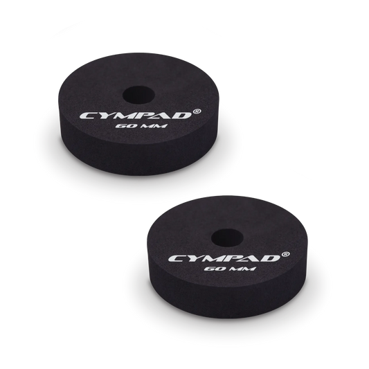 Two black Cympad Moderator cymbal washers, each 60mm in diameter, with a central hole and white printed branding that reads 'CYMPAD 60 MM.' The pads are round, made of cellular foam, and designed to reduce cymbal sustain and volume.
