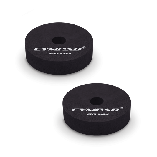 Two black Cympad Moderator cymbal washers, each 60mm in diameter, with a central hole and white printed branding that reads 'CYMPAD 60 MM.' The pads are round, made of cellular foam, and designed to reduce cymbal sustain and volume.