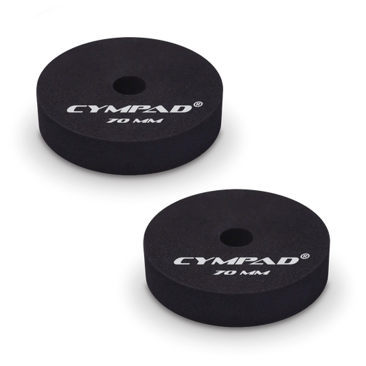 Two black Cympad Moderator cymbal washers, each 70mm in diameter, with a central hole and white printed branding that reads 'CYMPAD 70 MM.' The pads are round, made of cellular foam, and designed to reduce cymbal sustain and volume.