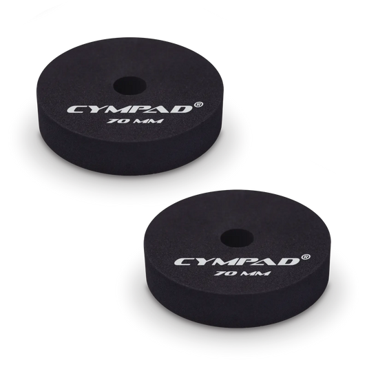 Two black Cympad Moderator cymbal washers, each 70mm in diameter, with a central hole and white printed branding that reads 'CYMPAD 70 MM.' The pads are round, made of cellular foam, and designed to reduce cymbal sustain and volume.