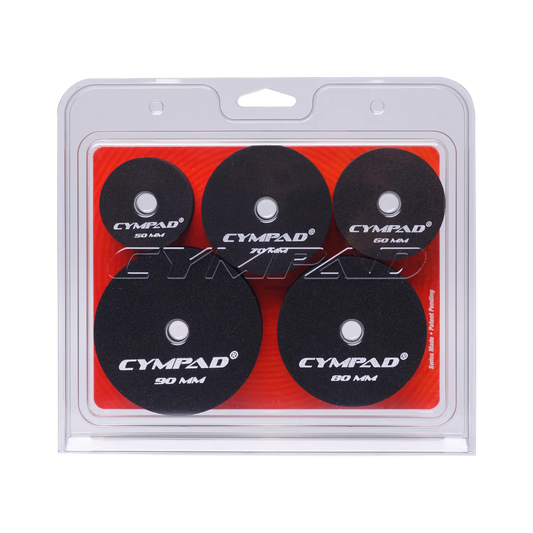 Front view of Cympad Moderator Super Set in retail packaging – Includes five pairs of cymbal washers in assorted sizes (50mm to 90mm), designed to control cymbal volume and overtones. Features black foam pads with white Cympad logos, set against a orange background inside clear clamshell packaging.