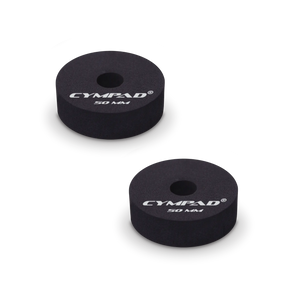 Two black Cympad Moderator cymbal washers, each 50mm in diameter, with a central hole and white printed branding that reads 'CYMPAD 50 MM.' The pads are round, made of cellular foam, and designed to reduce cymbal sustain and volume.