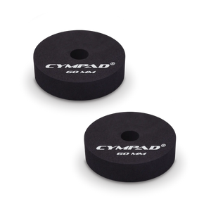 Two black Cympad Moderator cymbal washers, each 60mm in diameter, with a central hole and white printed branding that reads 'CYMPAD 60 MM.' The pads are round, made of cellular foam, and designed to reduce cymbal sustain and volume.
