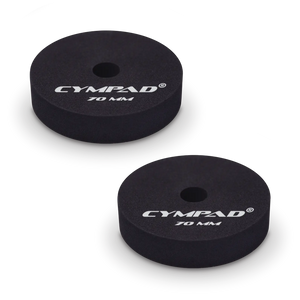 Two black Cympad Moderator cymbal washers, each 70mm in diameter, with a central hole and white printed branding that reads 'CYMPAD 70 MM.' The pads are round, made of cellular foam, and designed to reduce cymbal sustain and volume.