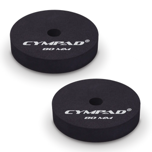 Two black Cympad Moderator cymbal washers, each 80mm in diameter, with a central hole and white printed branding that reads 'CYMPAD 80 MM.' The pads are round, made of cellular foam, and designed to reduce cymbal sustain and volume